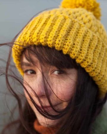 Jennifer Ramirez with mustard colored beanie