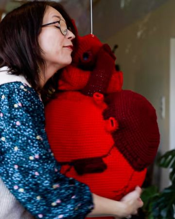 Eva hugging my crocheted heart